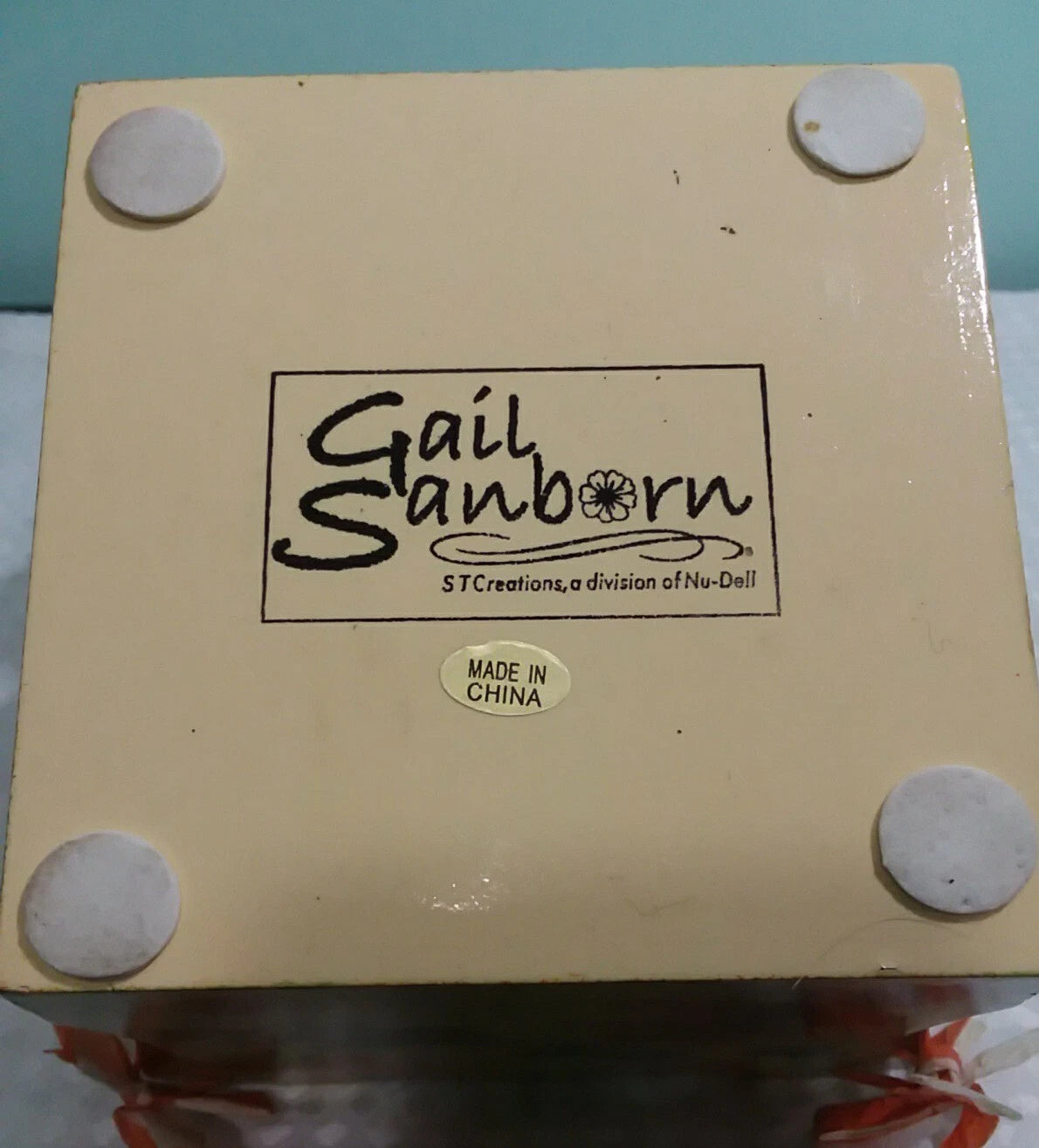 Box with 'Gail Sanborn' branding and 'Made in China' label on a light blue background.