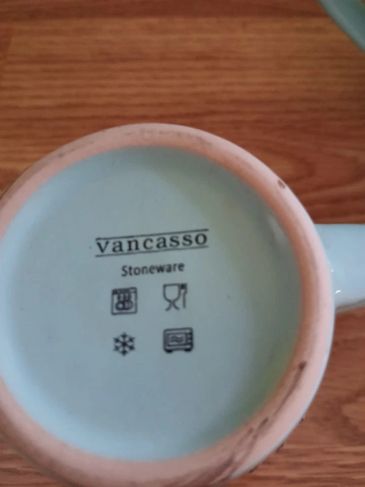 Ceramic mug with 'Vancasso Stoneware' branding on a wooden surface