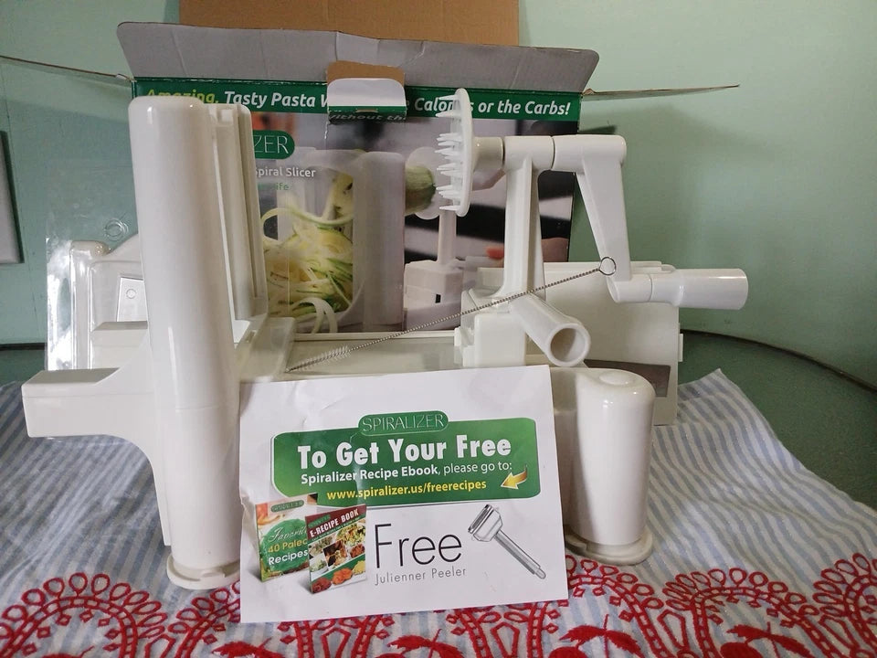 White spiralizer on a table with promotional material