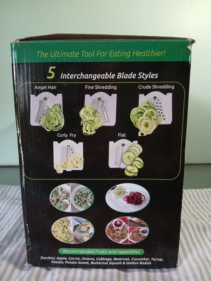 Box of a kitchen appliance with interchangeable blade styles on a striped fabric background