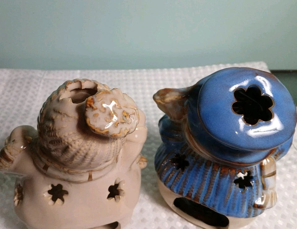 Two ceramic containers with star designs on a white surface.
