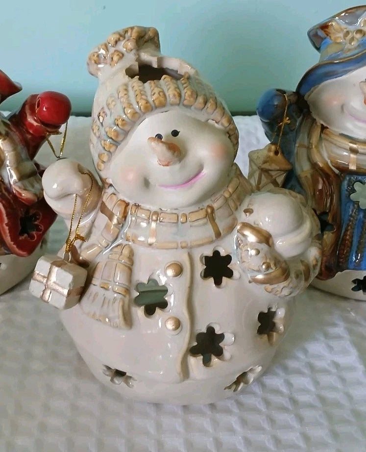Decorative ceramic snowman ornament with a blue background